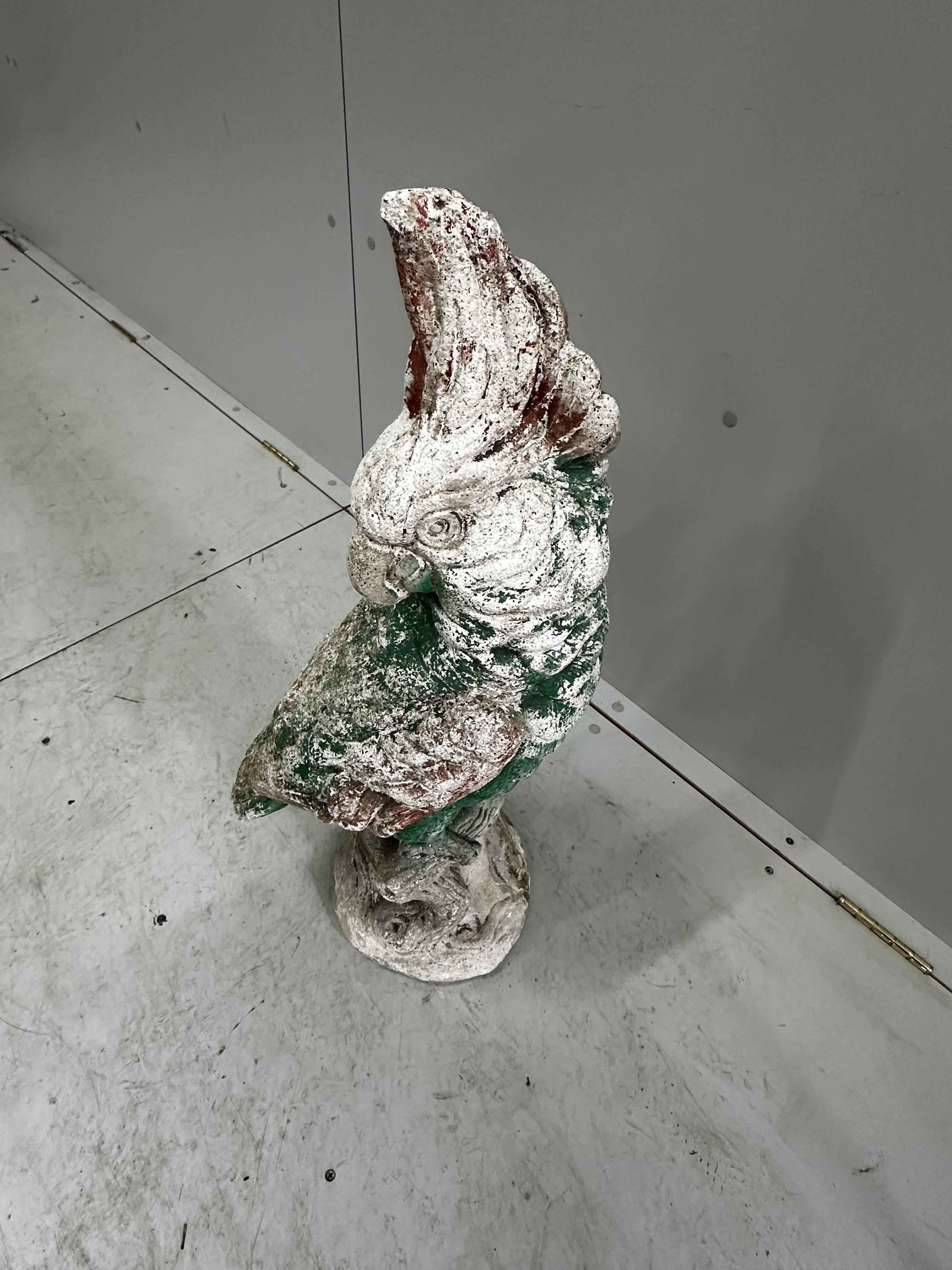 A painted reconstituted stone garden ornament modelled as a parrot, height 74cm